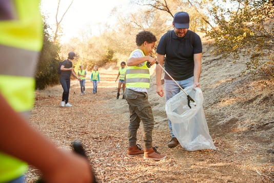 boy picking up trash